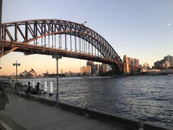 View of bridge over river at sunset