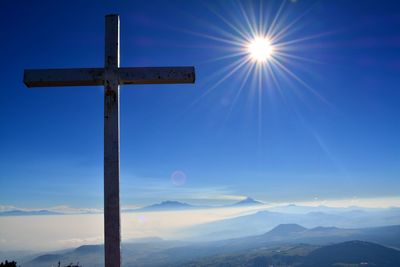 Scenic view of mountains against blue sky