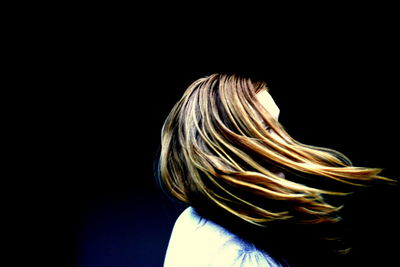 Close-up of person against black background