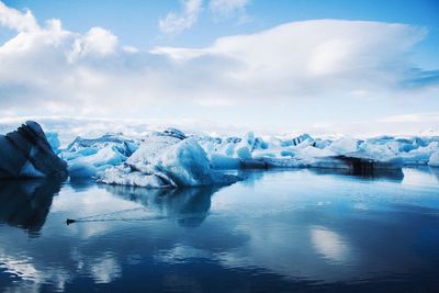 Scenic view of frozen lake against sky during winter