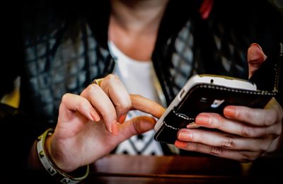 Midsection of woman using smart phone