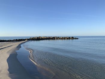 Scenic view of sea against clear blue sky