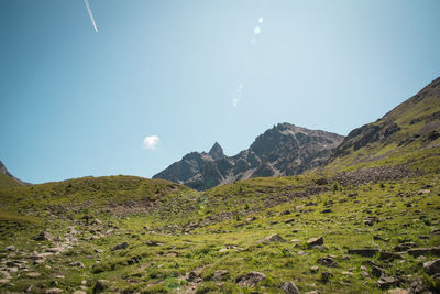 Scenic view of mountains against blue sky