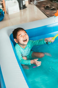 High angle view of boy swimming in pool