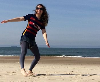 Full length of woman standing at beach