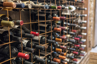 Close-up of wine bottles on rack