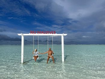 People on beach against sky