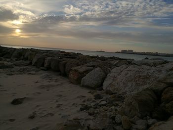 Scenic view of beach against sky during sunset