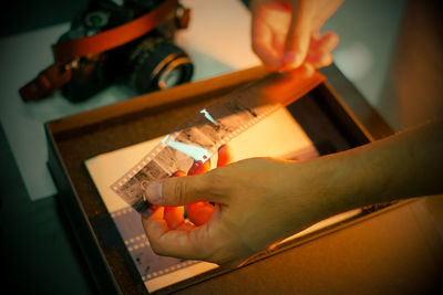 Cropped hand of man working at home