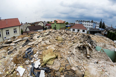 Rubble against houses in city