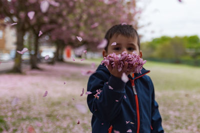 Portrait of boy holding plant