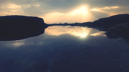 Scenic view of silhouette mountains against sky during sunset