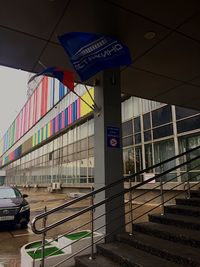 Information sign on road by buildings in city