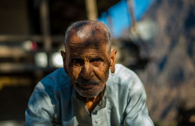 Portrait of man sitting outdoors