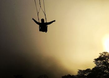 Low angle view of silhouette man against clear sky