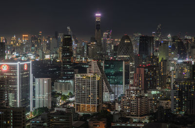 Aerial view of illuminated buildings in city at night