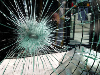 Close-up of broken glass window