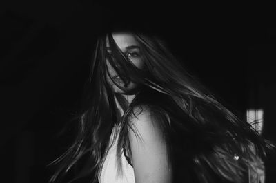 Portrait of beautiful woman in darkroom