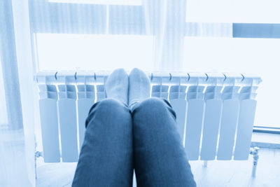 Low section of woman sitting on escalator