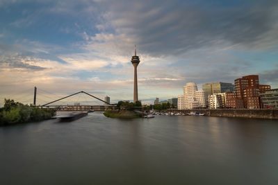 Bridge over river with buildings in background