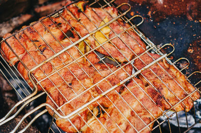 Delicious grilled meat with spices on barbecue.