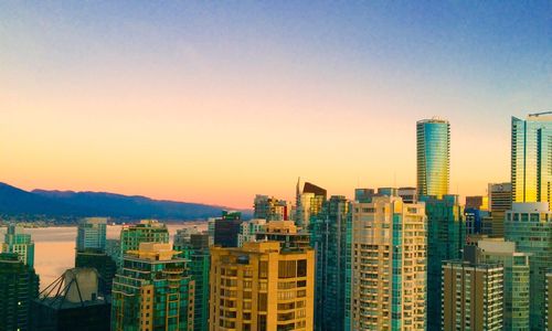 Buildings against sky at sunset