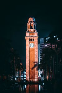 Low angle view of illuminated building against sky at night
