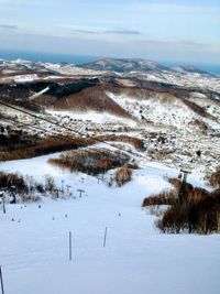 High angle view of snowcapped mountains against sky