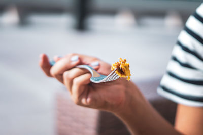 Close-up of hand holding ice cream