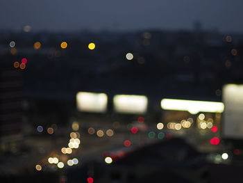 Defocused image of illuminated city at night