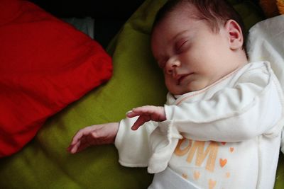 Close-up of cute baby boy sleeping on bed at home