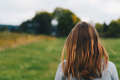 Rear view of woman on field