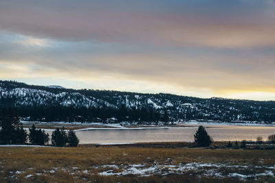 Scenic view of snowcapped landscape against sky during sunset