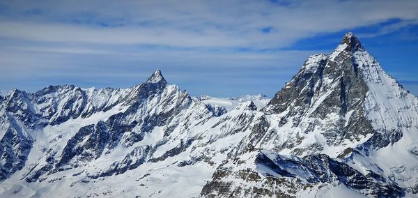 Scenic view of snowcapped mountains against sky