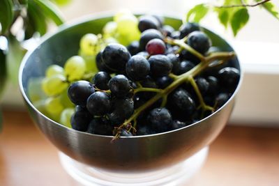 High angle view of grapes in bowl on table