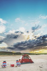 Scenic view of landscape against cloudy sky