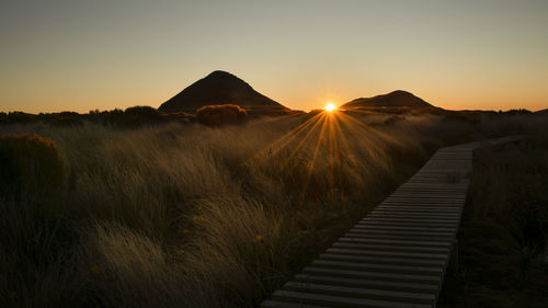 Scenic view of land against sky during sunset