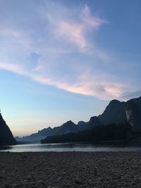Scenic view of mountains against cloudy sky