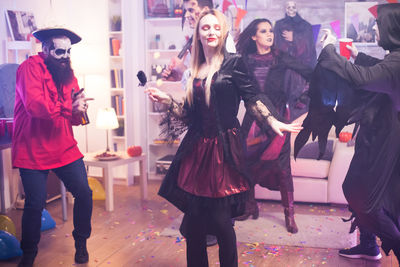 Full length of friends standing outdoors