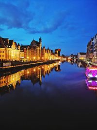 Reflection of buildings in city at night