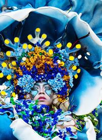 Close-up portrait of woman wearing flowers and costume