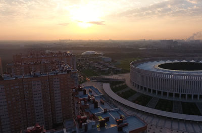 High angle view of buildings in city during sunset