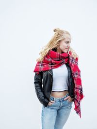 Young woman standing against white background