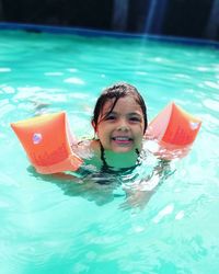 Portrait of young woman swimming in pool