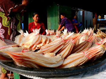 People in market stall for sale