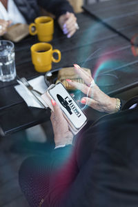 Woman reading fake news on cell phone