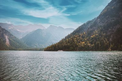 Scenic view of lake and mountains against sky