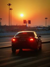 Car on street at sunset