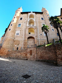 Low angle view of historic building against clear blue sky