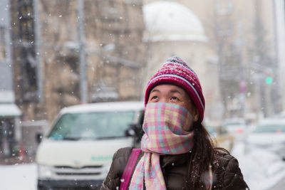 Woman looking away in park during winter